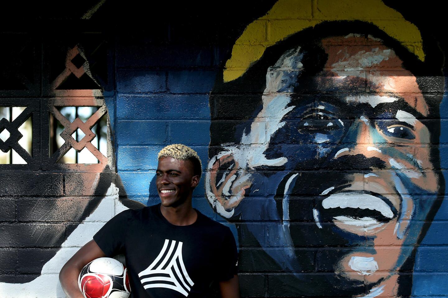 Galaxy forward Gyasi Zardes stands next to a mural of himself at Hawthorne Memorial Park. He grew up