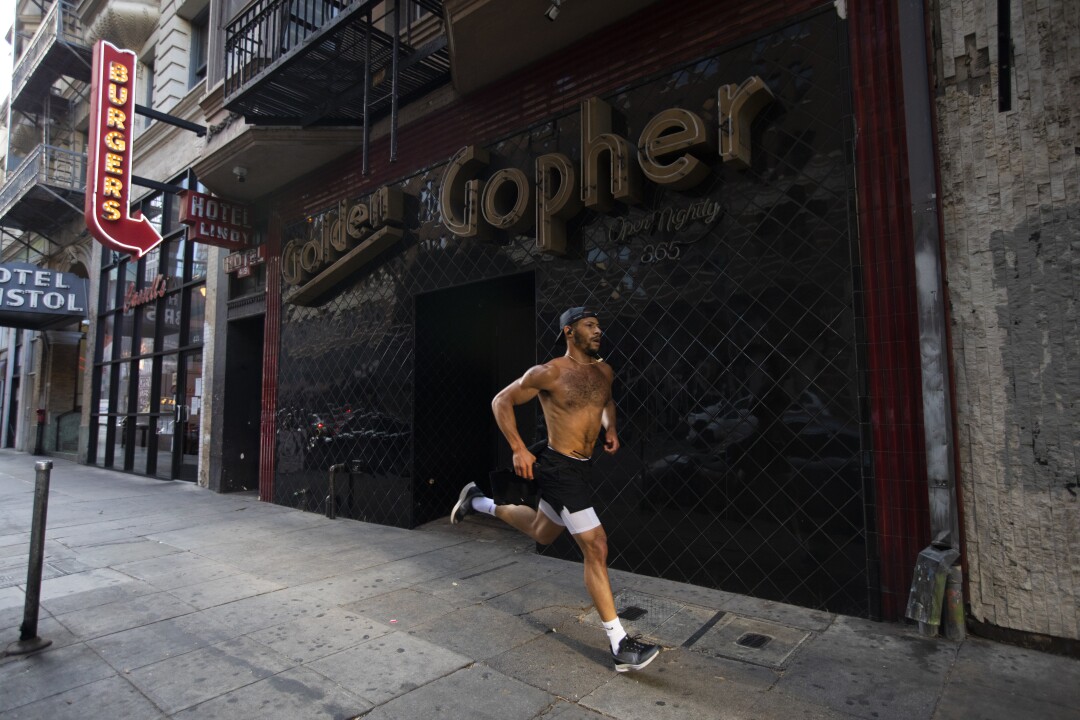 A man jogs in downtown Los Angeles.