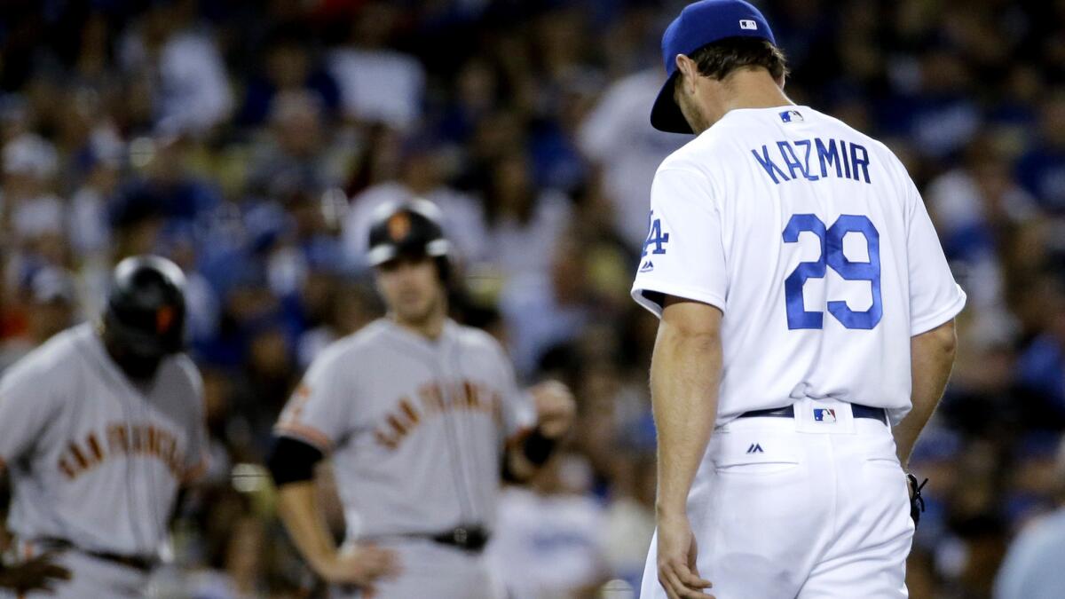 Dodgers starter Scott Kazmir heads to the dugout after getting pulled from the game against the Giants with the bases loaded in the fifth inning Saturday.
