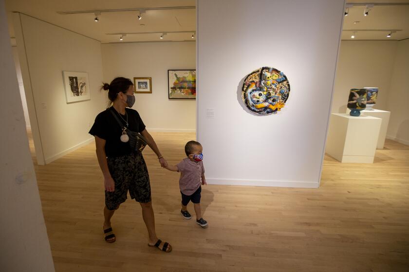 Jen Kim and her son Paxton, 3, look at art in the exhiit "An Earth Song, A Body Song" at the Orange County Museum of Art on Thursday, September 24.