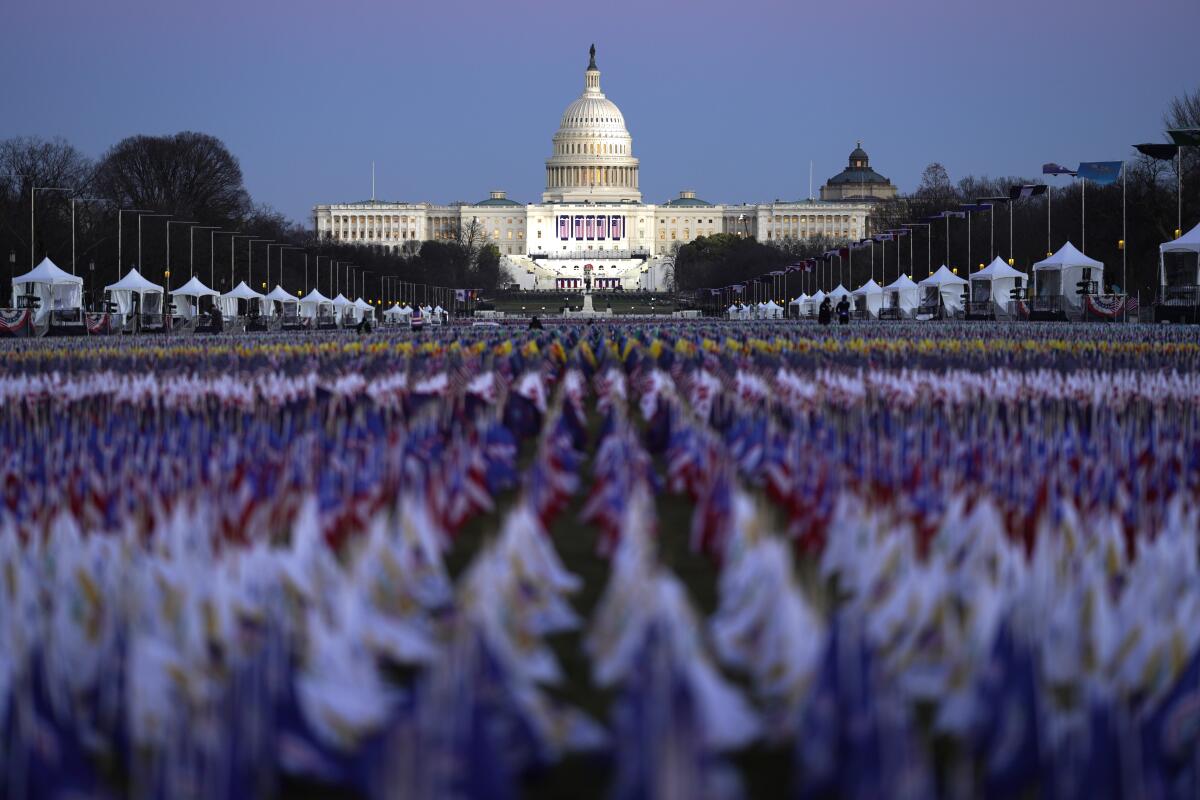 Flags line the National Mall, with the U.S. Capitol behind them, on Tuesday.
