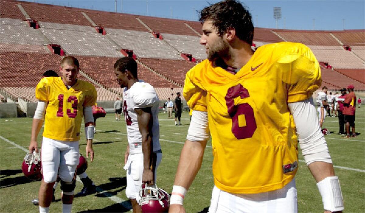 USC quarterbacks Max Wittek, left, and Cody Kessler, right, walk off the field after a team scrimmage at the Coliseum on Aug. 16, 2013