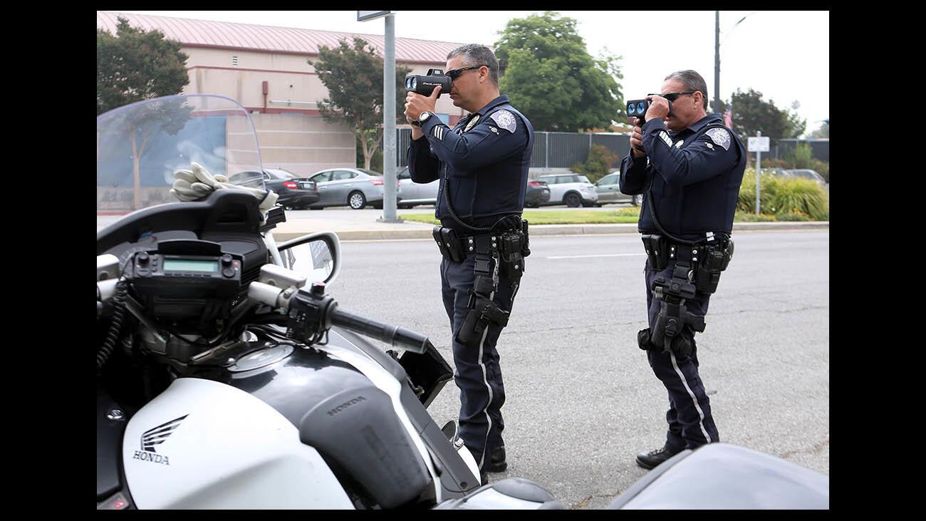 Glendale Police officers Roman Fernandez, left, and Joe Borbon, right, check for speeding cars during speed enforcement detail, on the 1700 block of South Brand Blvd., in Glendale on Friday, June 22, 2018. The officers caught speeding motorists going from 40 to 54 miles per hour on the 25-mph zone. Brand Blvd. speed limit is 25 mph from San Fernando Road on the south to Glenoaks at the north end. An additional speed enforcement detail will be out tomorrow as well as evening time sobriety check point, according to the officers.