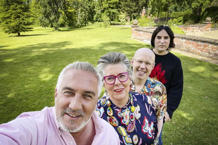 Four people pose for a selfie on the grounds of a British estate