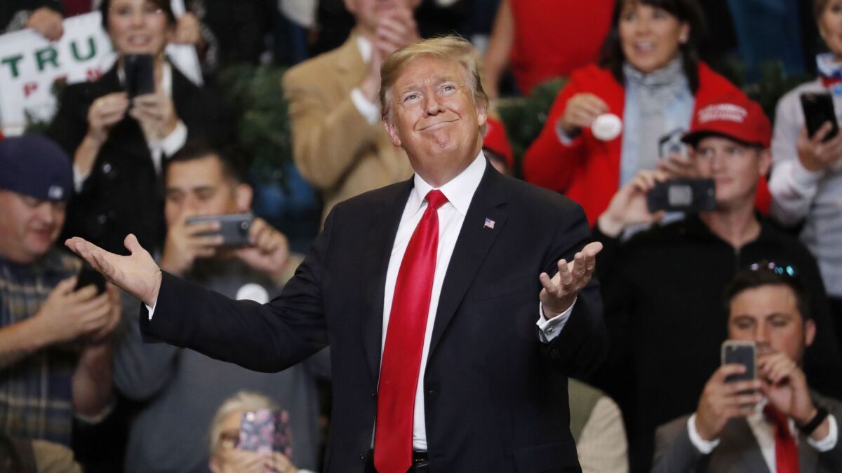 President Trump gestures as he acknowledges the fake snow that fell as he entered the Mississippi Coast Coliseum for a rally Nov. 26, 2018, in Biloxi, Miss. (AP Photo/Rogelio V. Solis)