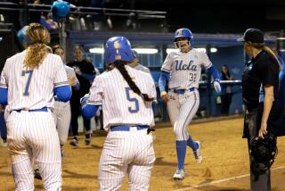 WESTWOOD, CA - MAY 23, 2024: UCLA pinch runner Gabriela Jaquez (32) scores after UCLA infielder Jordan Woolery (15) hit a 3-run homer against Georgia in the fifth inning during the NCAA Division I Softball Los Angeles Super Regional at Easton Stadium on the UCLA campus on May 23, 2024 in Westwood, California.UCLA Maya Brady (7) and UCLA Savannah Pola (5) greet her a home plate.(Gina Ferazzi / Los Angeles Times)