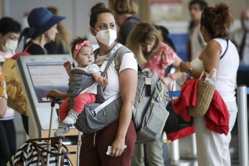 A rush of out-of-town travelers for the Fourth of July holiday weekend at Los Angeles International Airport.