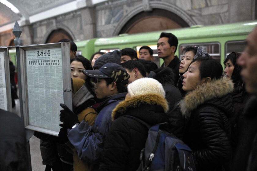 Subway commuters in Pyongyang, North Korea, read the news of Jang Song Taek's execution. More executions of older government officials are expected.