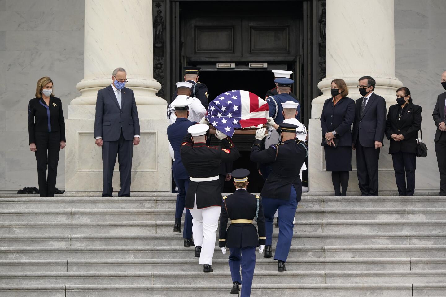 The casket of Justice Ruth Bader Ginsburg is carried by a military honor guard to lie in state at the U.S. Capitol