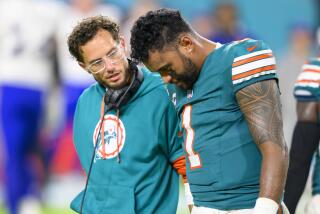 Miami Dolphins quarterback Tua Tagovailoa walks off of the field with head coach Mike McDaniel after suffering an injury