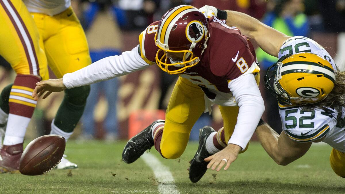 Redskins quarterback Kirk Cousins fumbles the ball as he is sacked by Packers linebacker Clay Matthews during the first half Sunday.