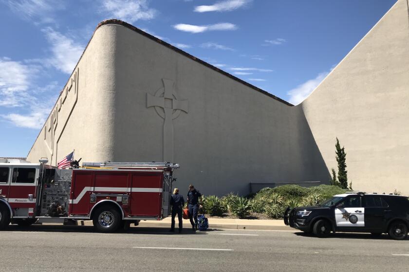 Laguna Woods, CA - May 15: Emergency first responder walk in front of Geneva Presbyterian Church on Sunday, May 15, 2022 in Laguna Woods, CA. One person was killed and four others were critically wounded Sunday during a shooting at a church in Laguna Woods.(Allen J. Schaben / Los Angeles Times)