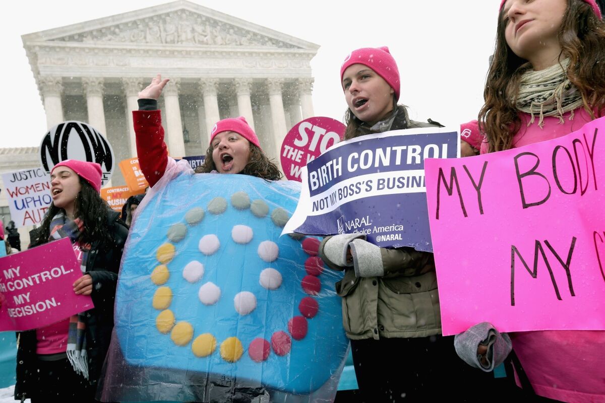 Demonstrators rally outside the U.S. Supreme Court in 2014 during oral arguments in the Hobby Lobby case on whether a closely-held for-profit company could refuse to provide health insurance coverage for birth control for its employees.