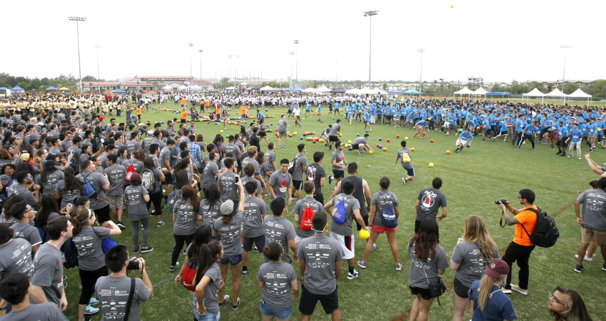 Four opposing teams furiously throw toward each other during a four-quadrant dodgeball game at UC Irvine's Anteater Recreation Center sports field on Tuesday, Sept. 20, 2016. The university attempted to break a Guinness World Record for the largest game of four-quadrant dodgeball. The university was expecting about 3,000-4,000 students to participate.