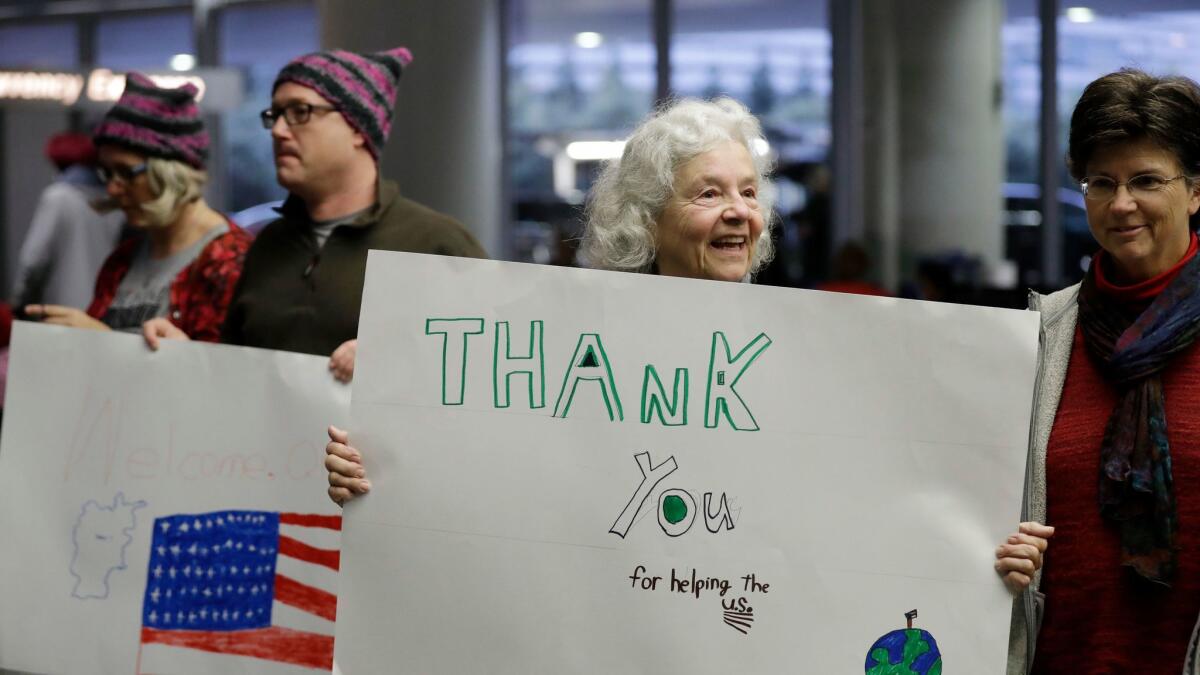 Supporters wait for U.S. Army interpreter Qismat Amin to arrive from Afghanistan at San Francisco International Airport on Feb. 8.