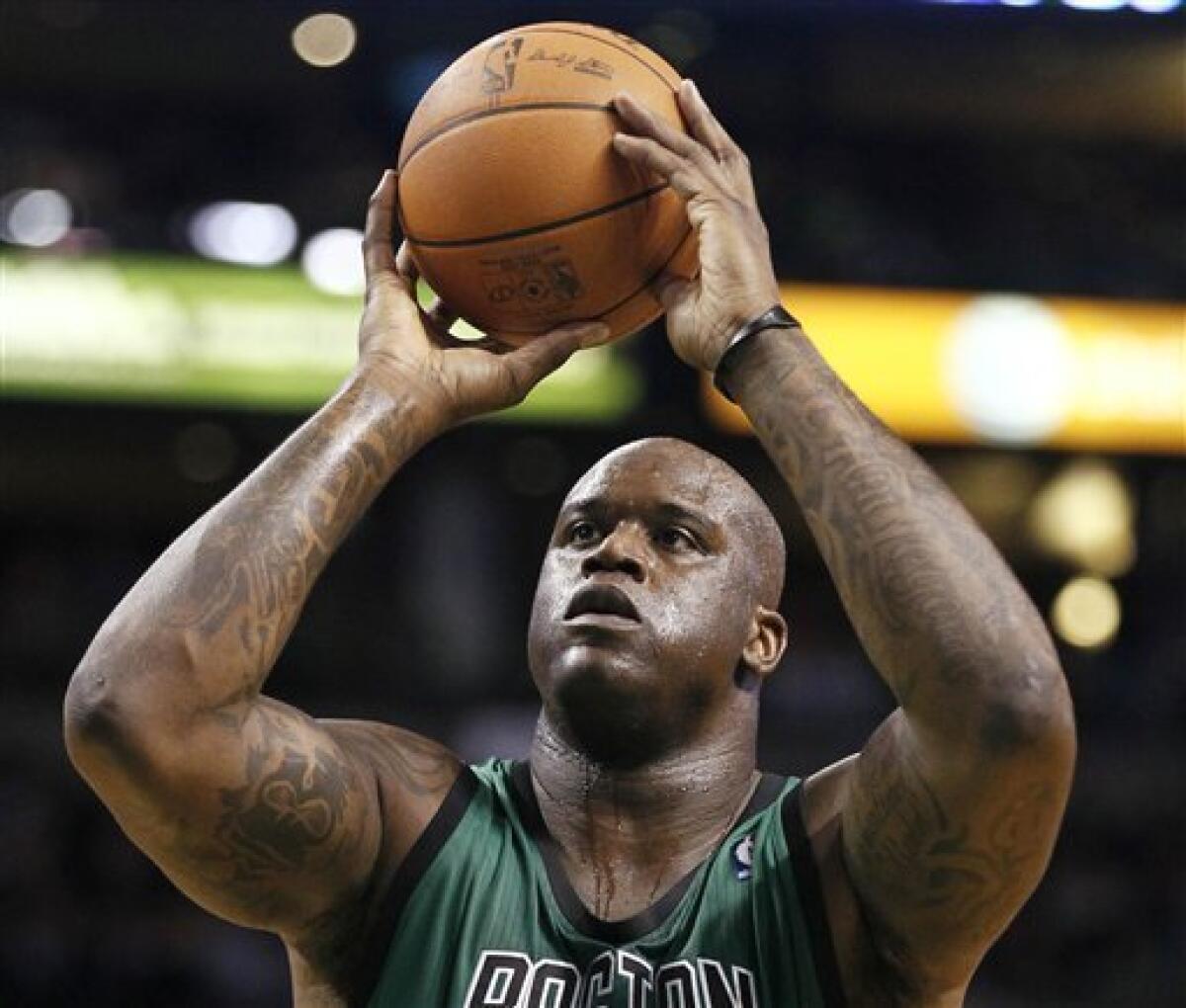 FILE- In this Nov. 26, 2010 file phtoo, Boston Celtics' Shaquille O'Neal wears a Power Balance bracelet on his left wrist during a NBA basketball game against the Toronto Raptors in Boston. Australian authorities on Tuesday, Jan. 4, 2010 said the California-based company behind the wildly popular Power Balance wristbands and pendants has no business claiming that they can improve balance, strength and flexibility. And they even got Power Balance to admit it. (AP Photo/Winslow Townson, File)