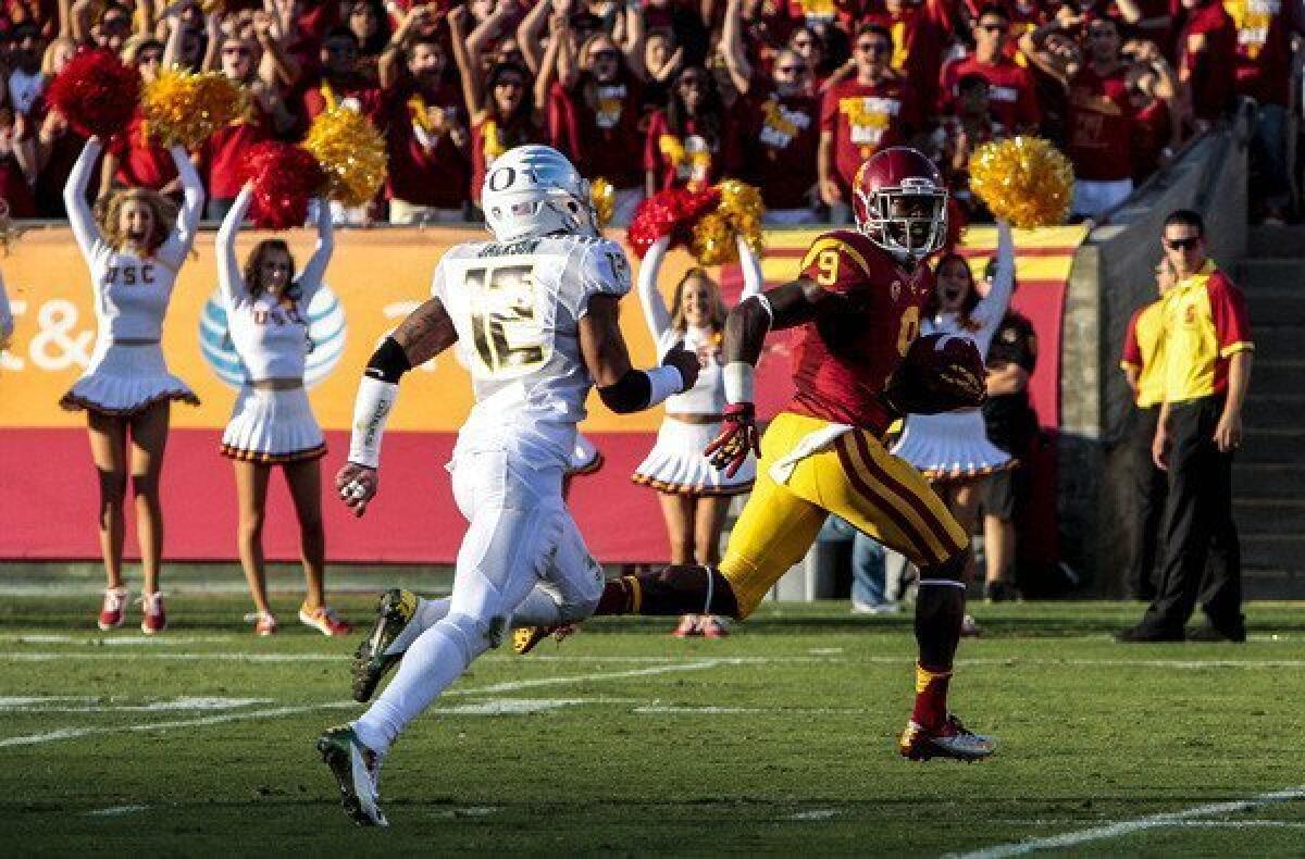 Trojans receiver Marqise Lee beats Ducks defensive back Brian Jackson to the end zone for a touchdown in the first half Saturday.