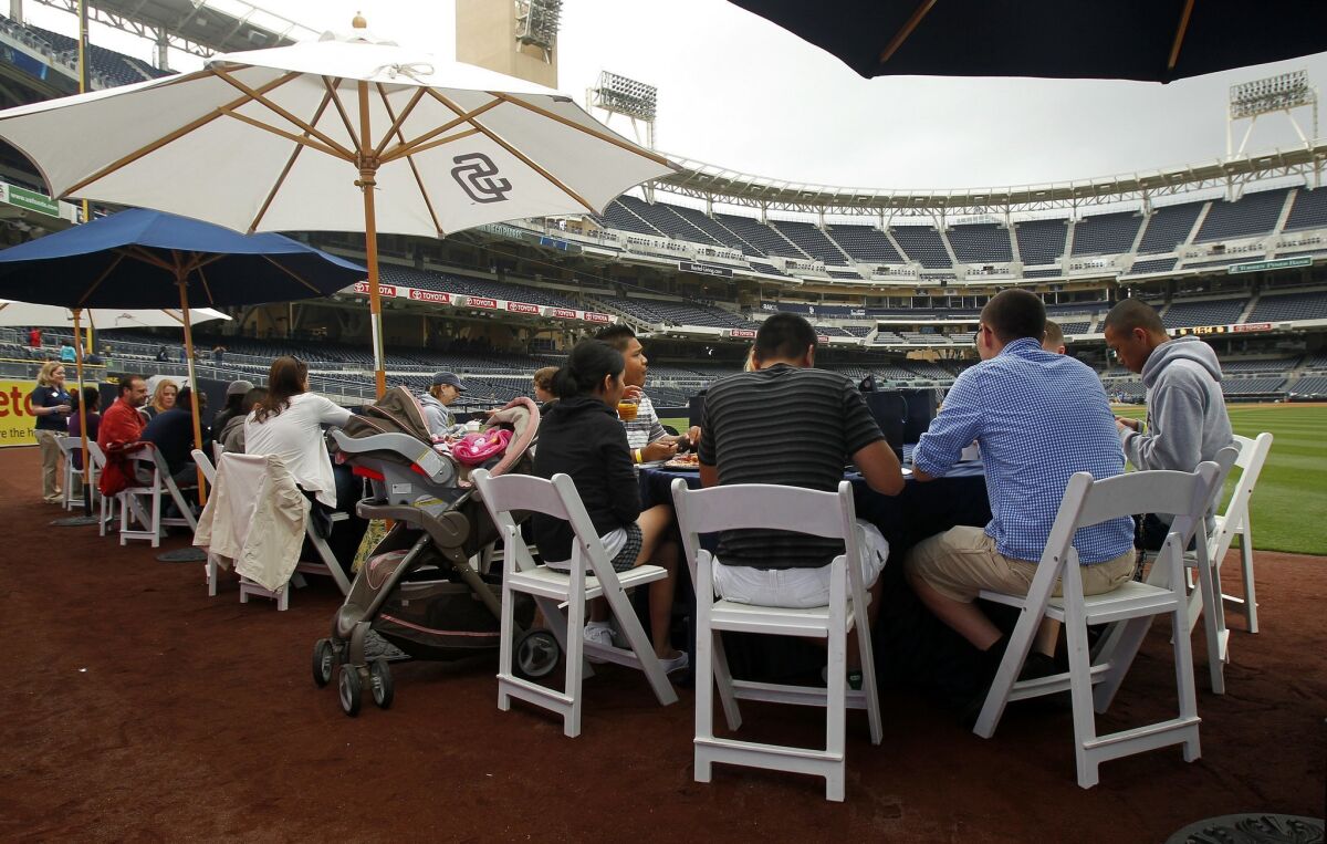 Military families have brunch on the warning track at Petco Park before the San Diego Padres Military Spouse Appreciation Game. — K.C. Alfred / UT San Diego