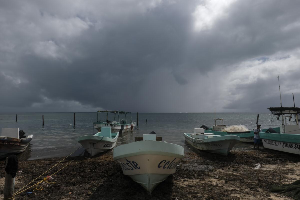 Fishermen secure boats in Cancun, Mexico, ahead of Hurricane Delta.