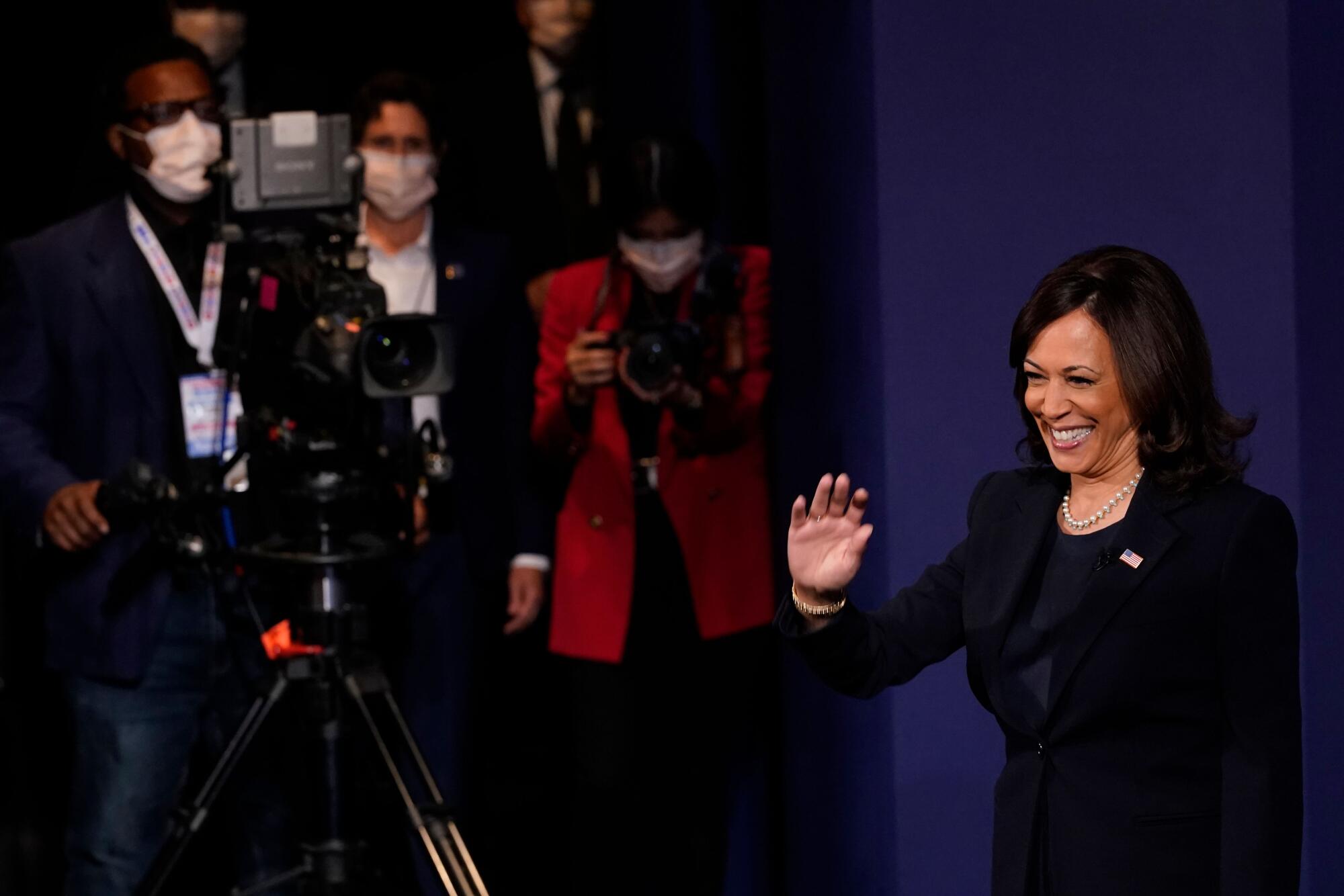 Kamala Harris waves to people at the debate hall