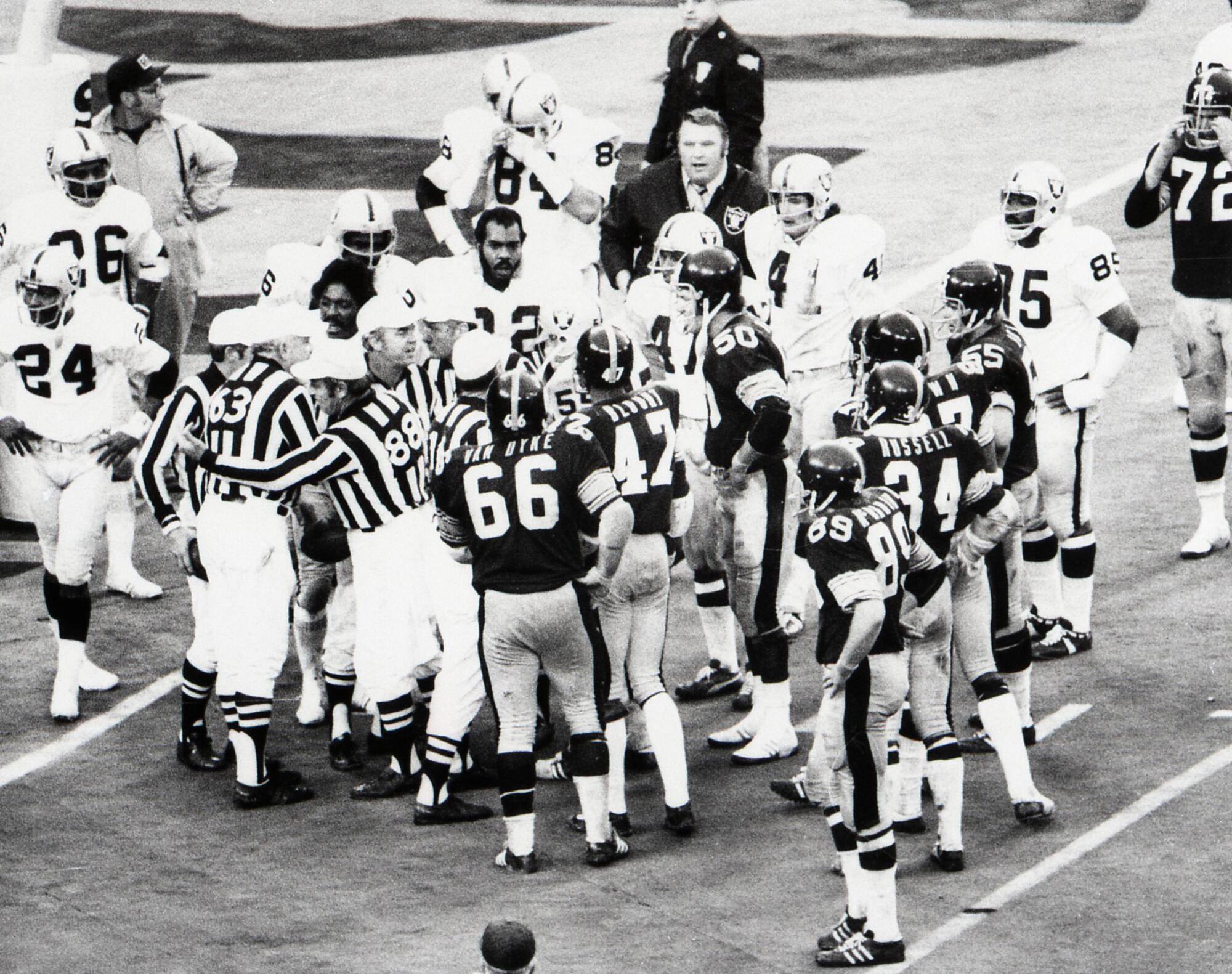 NFL officials confer on the validity of the "Immaculate Reception" as Raiders and Steelers huddle around them. 