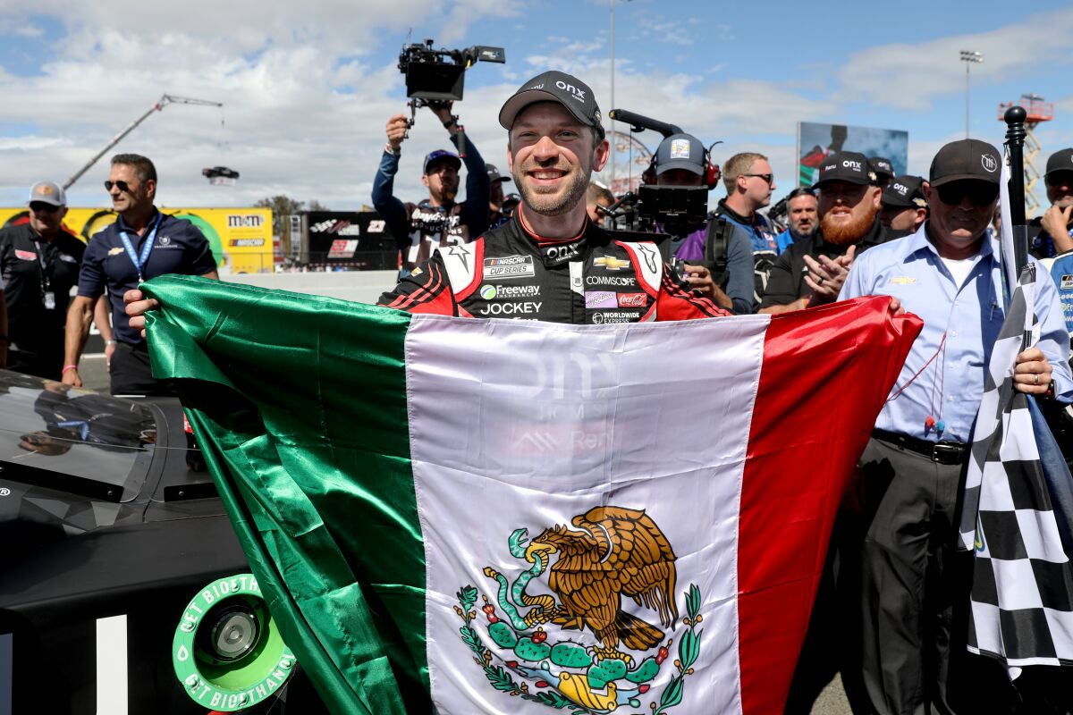 Daniel Suárez celebrates with the Mexican flag after winning the Toyota / Save Mart 350 at Sonoma Raceway.