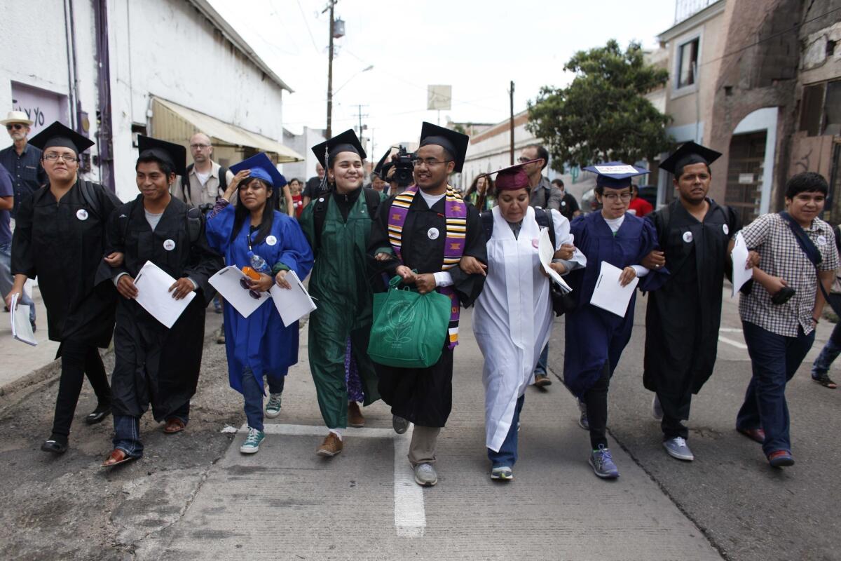In July, immigration rights activists, wearing their school graduation caps and gowns to show their desire to finish school in the U.S., marched with linked arms to the U.S. port of entry where they requested humanitarian parole in Nogales, Mexico. The activists, known as the "Dream 9," were later arrested after attempting to cross the border. They were released from federal custody in August.