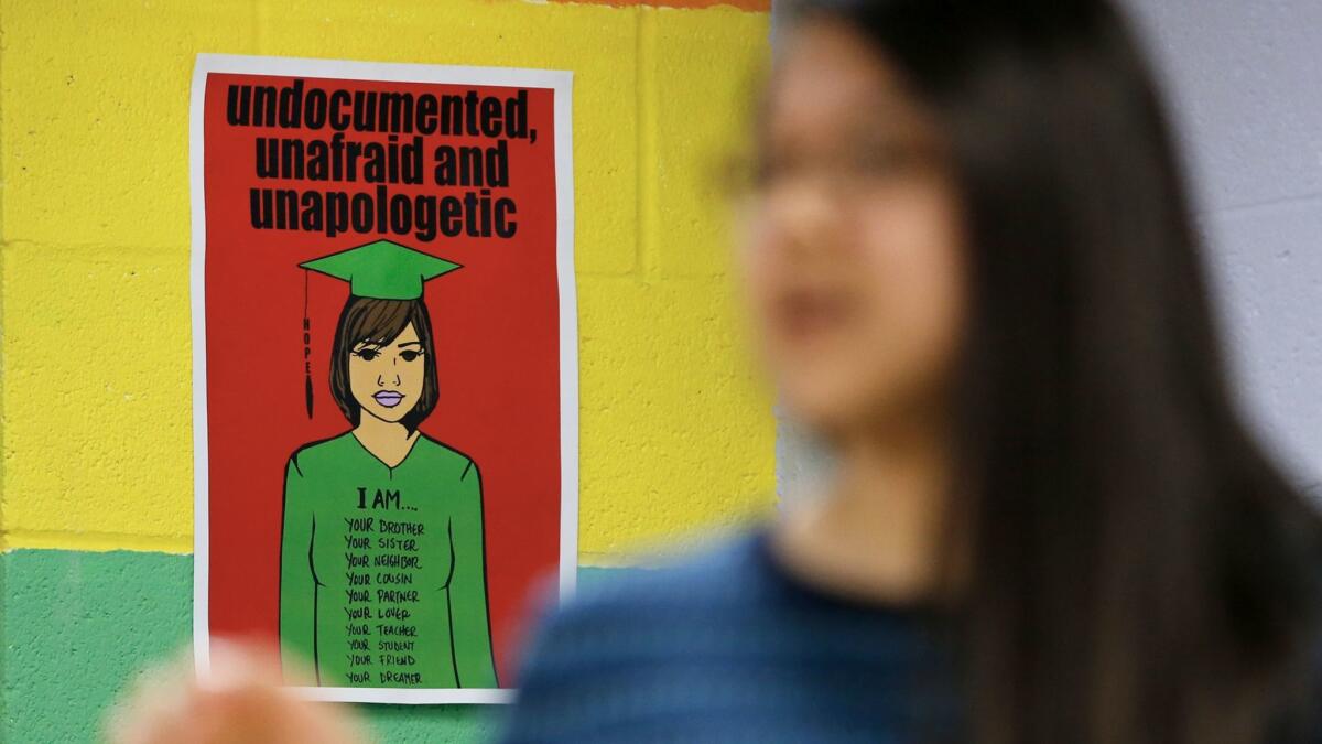 A detail of a poster on the wall as Alma Sanchez, Kid City program assistant, teaches an after-school college prep class at Kid City.