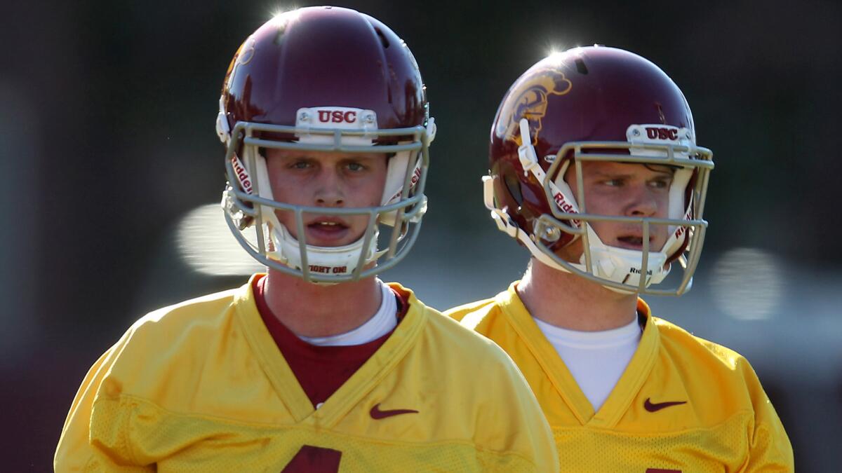 USC quarterbacks Max Browne, left, and Sam Darnold take snaps on the first day of spring practice on March 8.