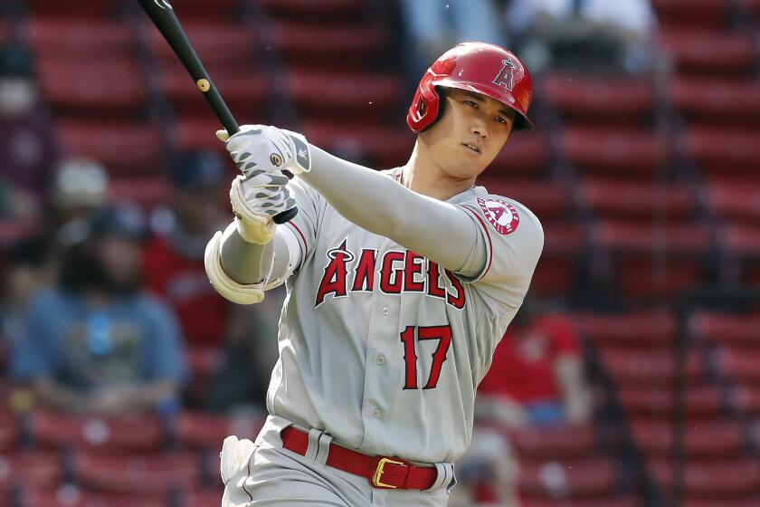 Los Angeles Angels' Shohei Ohtani takes a practice swing during the first inning of a baseball game.