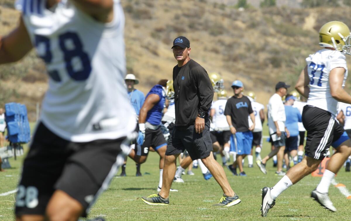 UCLA Coach Jim Mora directs practice during the Bruins' training camp at Cal State San Bernardino on Aug. 4.