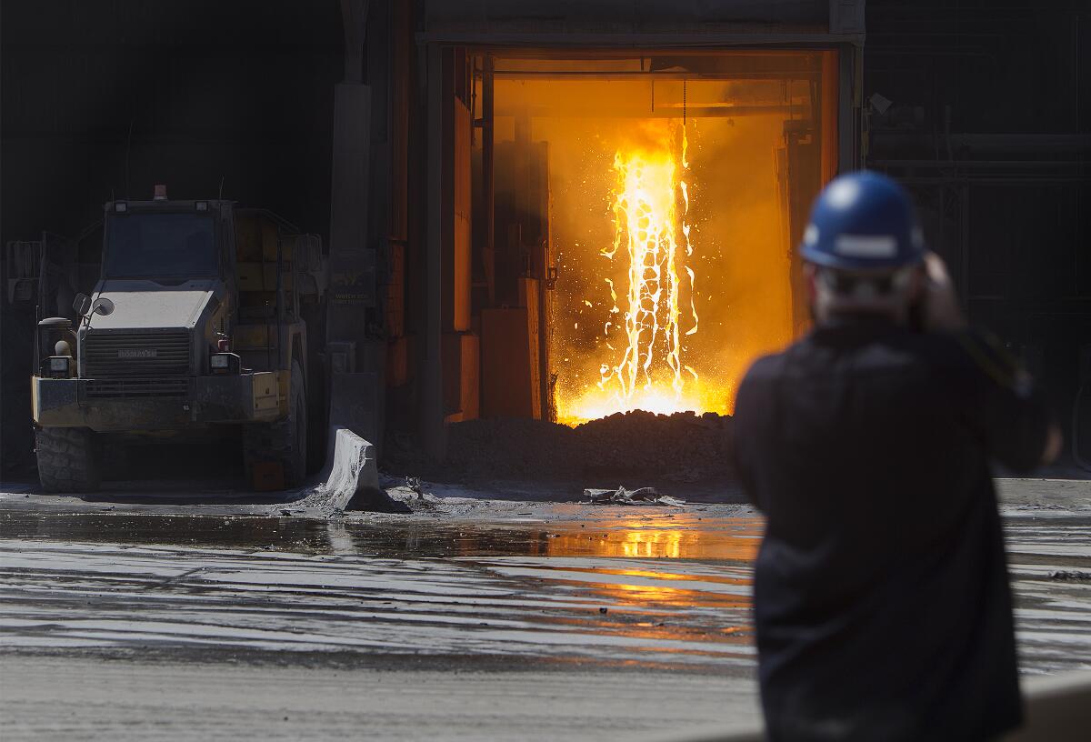 Hot metal flares up at a steel mill