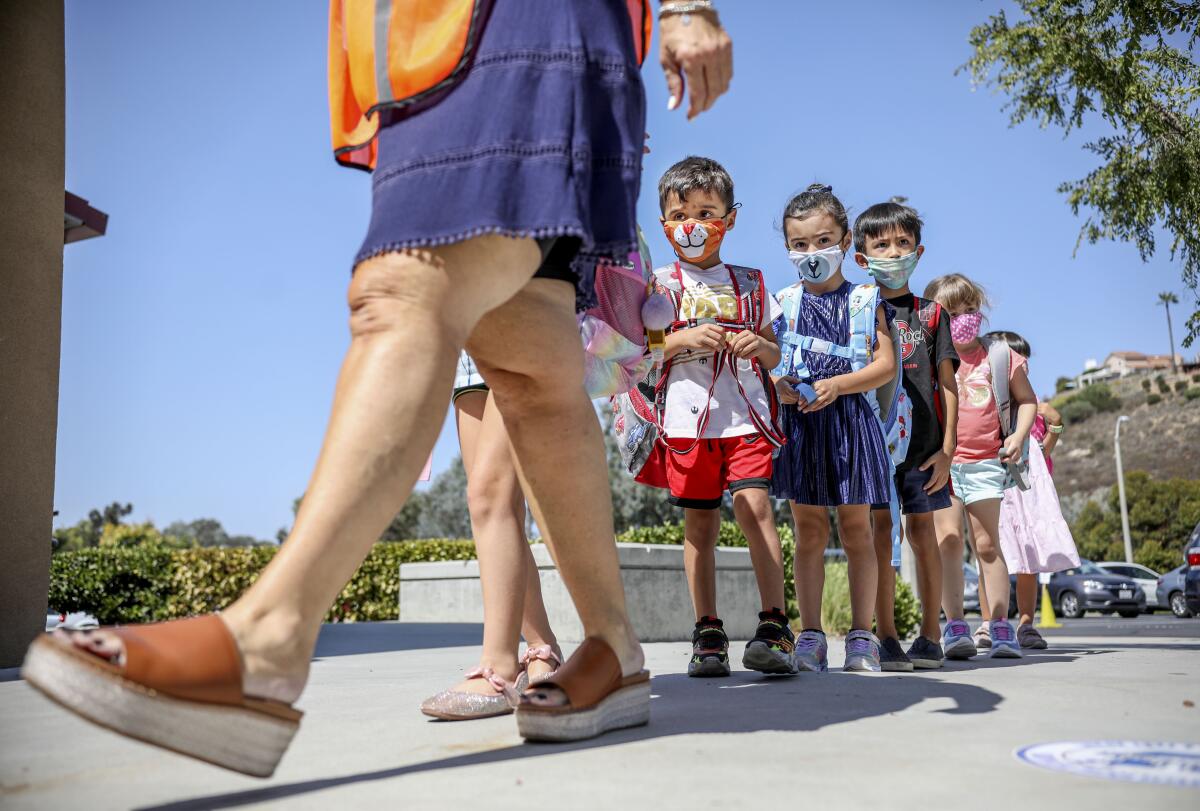 Kindergarten students walk to class at Sunset Hills Elementary School in Poway on October 1.