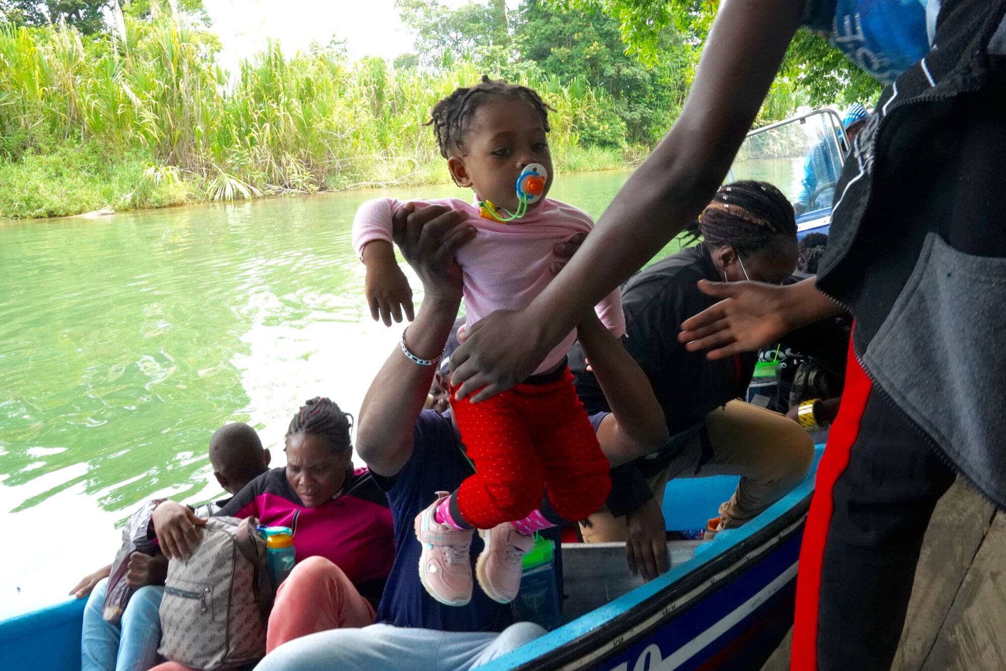 Migrants arrive by boat in the Colombian town of Acandi