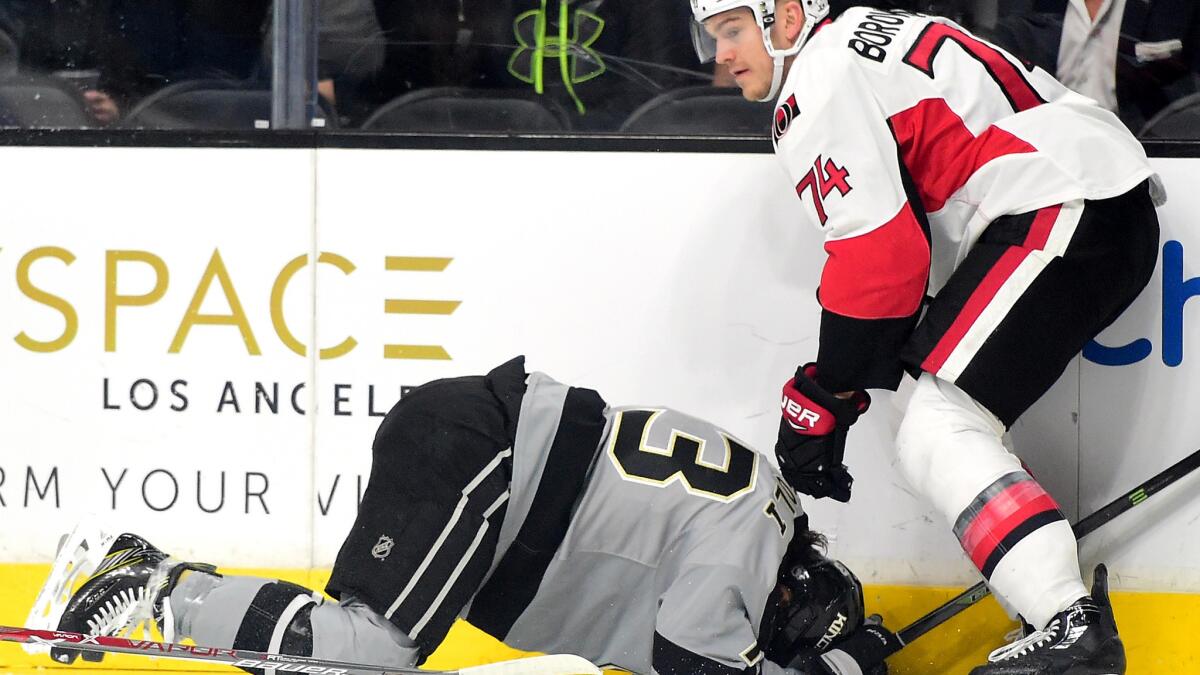 Senators defenseman Mark Borowiecki stands over Kings center Tyler Toffoli after boarding and injuring him during the first period Saturday night.