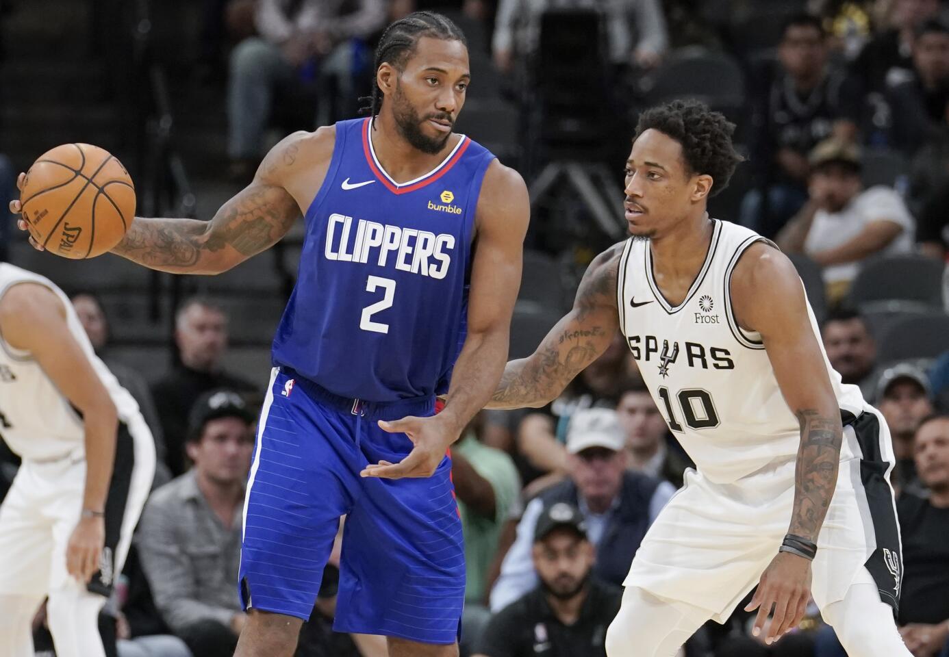 Clippers forward Kawhi Leonard (2) looks to pass while being defended by Spurs guard DeMar DeRozan during the second half of a game Nov. 29. n NBA basketball game, Friday, Nov. 29, 2019, in San Antonio. (AP Photo/Darren Abate)