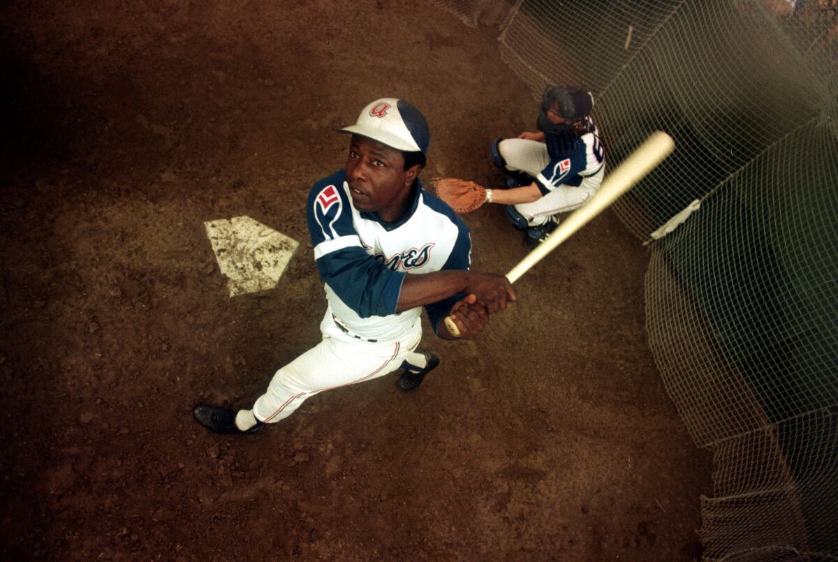Atlanta Braves outfielder Hank Aaron swings a bat at home plate during spring training in 1974.