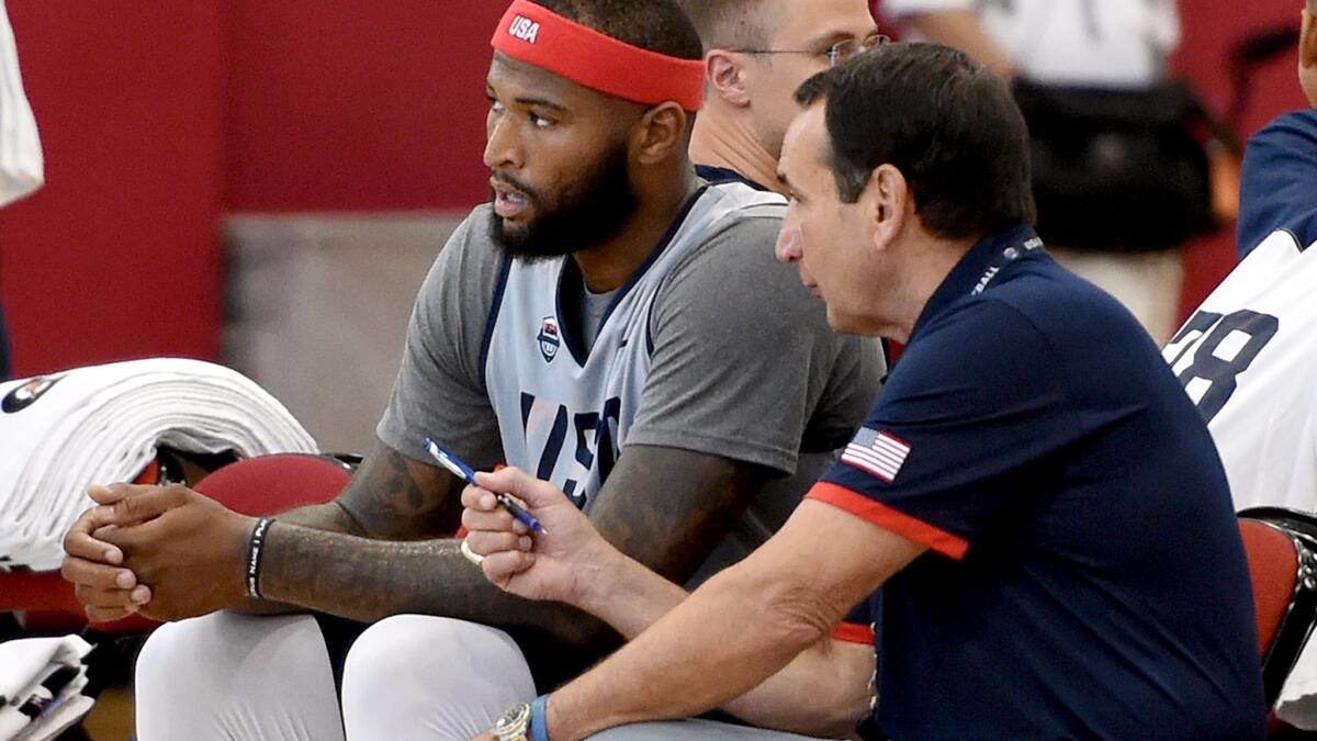 Coach Mike Krzyzewski, right, chats with center DeMarcus Cousins during a Team USA practice.