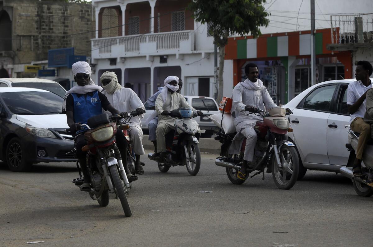 Motorbikes and autos on the street during rush hour in N'Djamena, Chad
