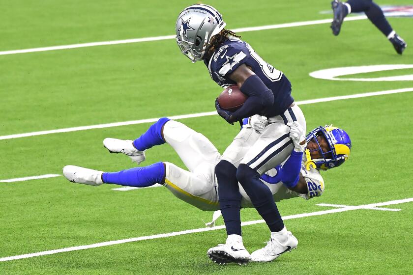 INGLEWOOD, CALIFORNIA SEPTEMBER 13, 2020-Rams Troy Hill brings down Cowboys wide receiver CeeDee Lamb after a catch in the 2nd quarter at SoFi Stadium in Inglewood Sunday. (Los Angeles Times/Wally Skalij)