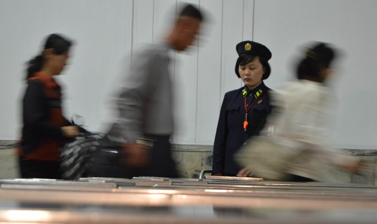 Commuters hurry through a subway station in Pyongyang, North Korea.