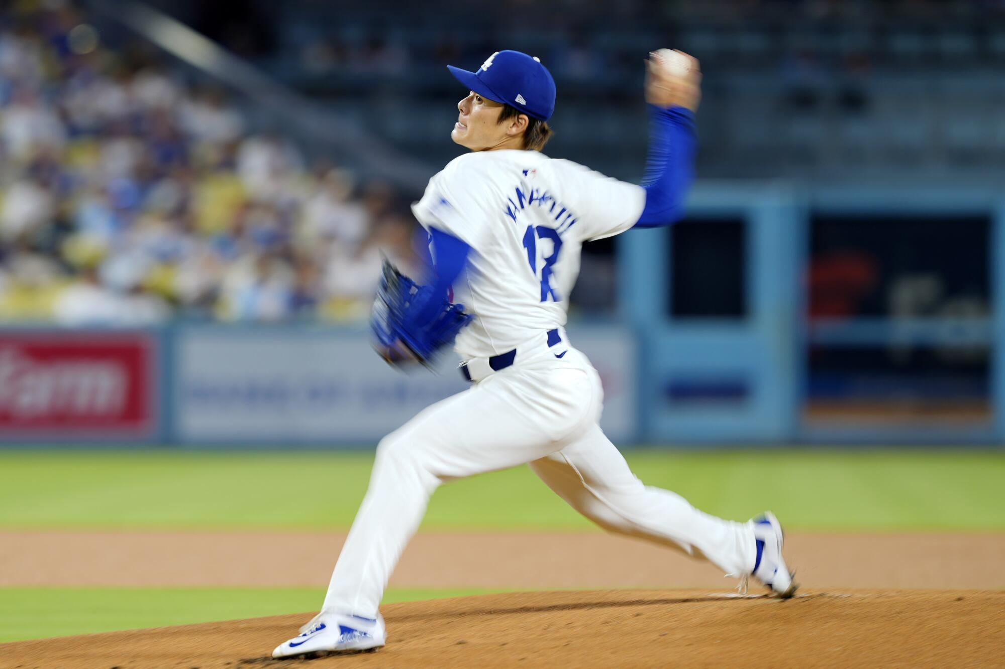 Yoshinobu Yamamoto throws to the plate.