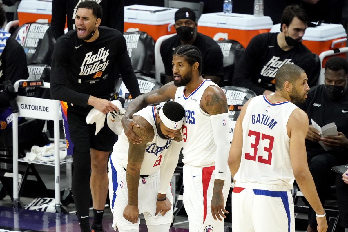 Clippers forward Paul George embraces teammate Marcus Morris Sr., left, after he was fouled in Game 5.