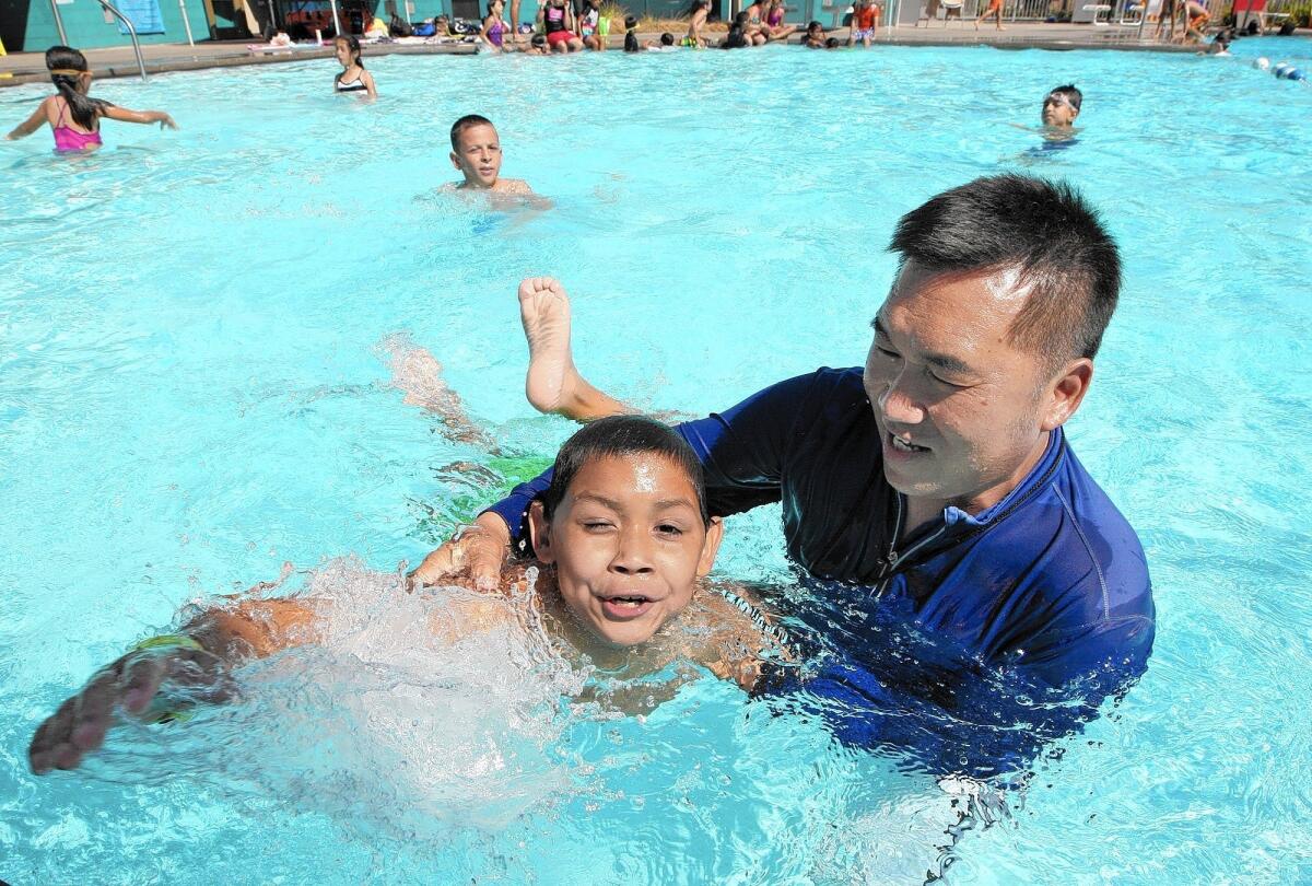 Edison Elementary swim instructor Bon Sam gives Henry Gamez, 9, a swimming lesson on Friday, September 26, 2014. Edison is the only elementary school in the district to use a pool for physical education.