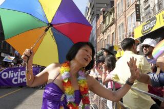 Toronto mayoral candidate Olivia Chow high-fives a spectator as she walks in the Toronto Pride Parade, Sunday June 25, 2023. (Chris Young/The Canadian Press via AP)
