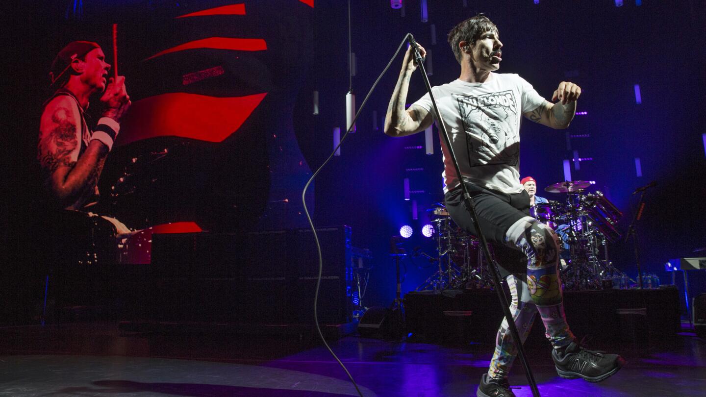 The Red Hot Chili Peppers' Anthony Kiedis, right, with drummer Chad Smith projected on screen in concert at Staples Center.