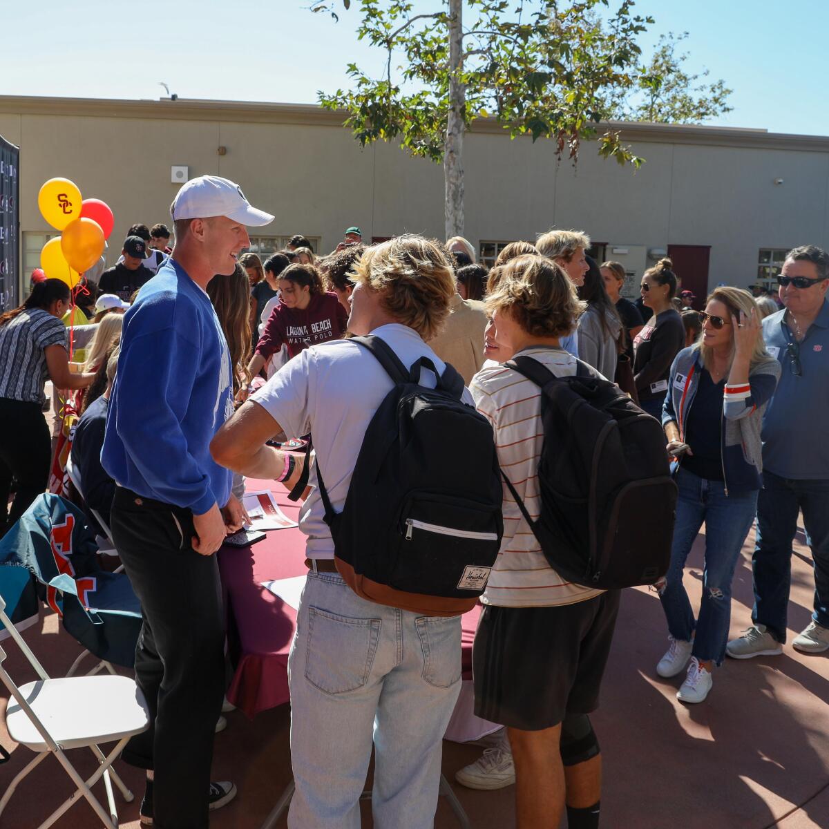 Laguna Beach tight end Ryner Swanson, left, meets with friends after signing with the BYU football program on Wednesday.