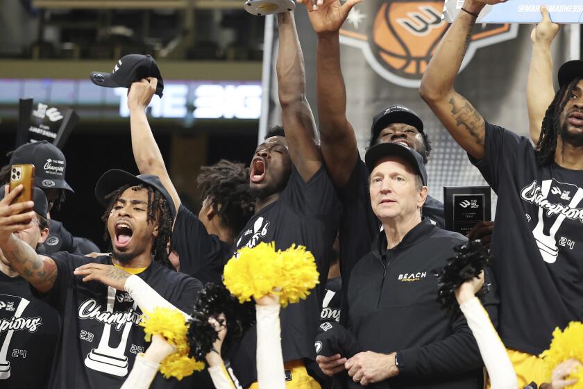 Long Beach State players and head coach Dan Monso, front right, celebrate.