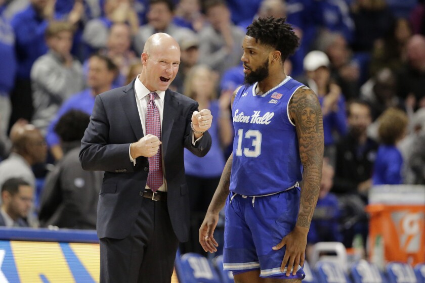 FILE - In this Nov. 17, 2019, file photo, Seton Hall head coach Kevin Willard, left, talks with guard Myles Powell (13) during the first half of an NCAA college basketball game against Saint Louis in St. Louis. Powell has sued Seton Hall, coach Kevin Willard and a staff member for failing to diagnose a knee injury during his senior season, causing him to suffer severe physical and financial damage. (AP Photo/Jeff Roberson, File)