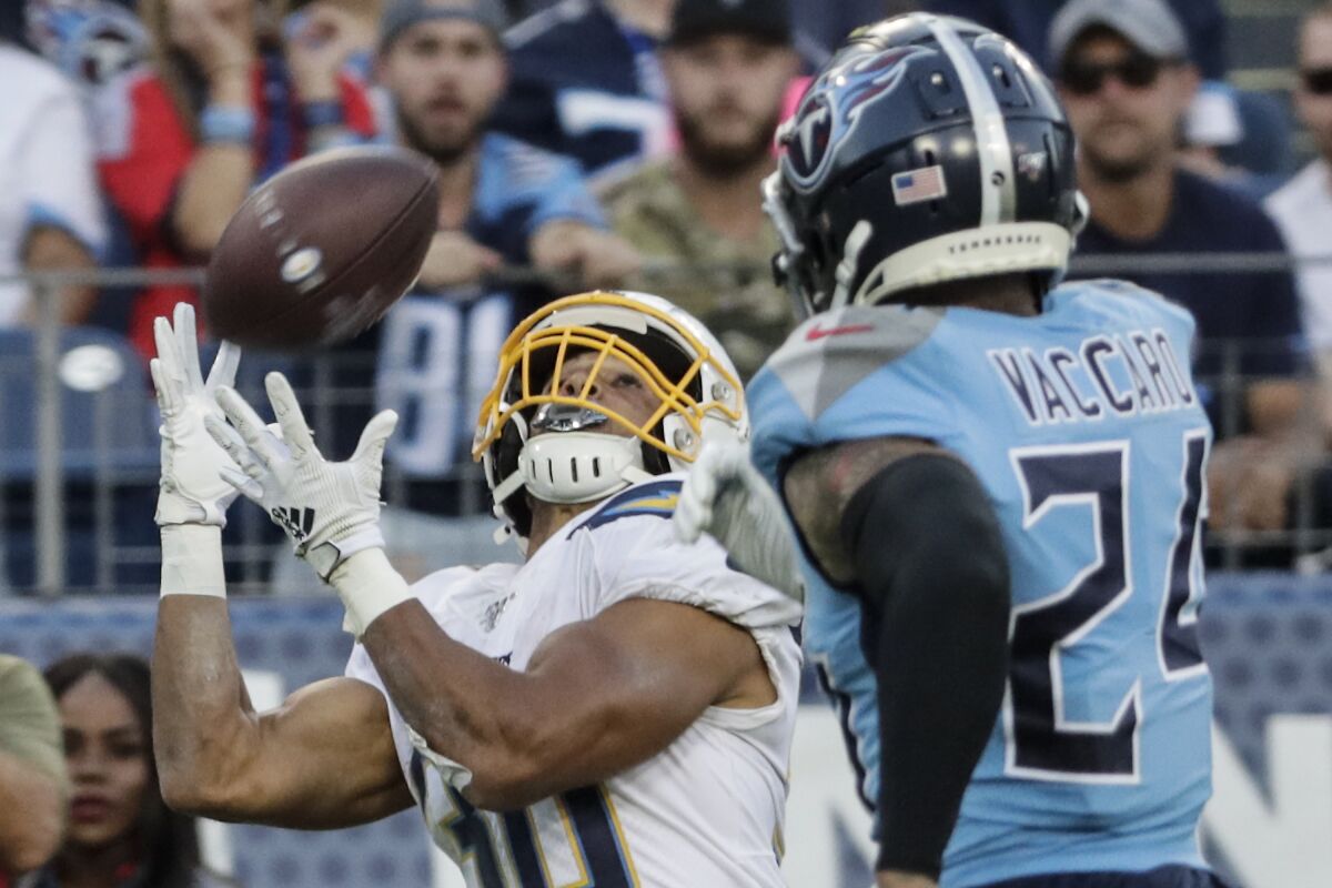 Chargers running back Austin Ekeler (30) beats Tennessee Titans strong safety Kenny Vaccaro (24) for a long touchdown pass during fourth quarter action on Sunday in Nashville, Tenn.